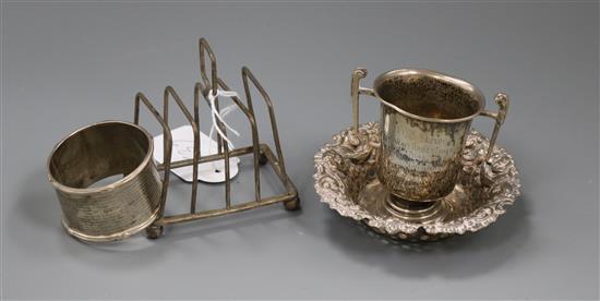 A silver serviette ring and three other silver items.